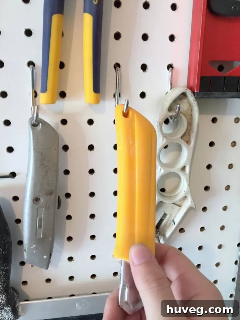 Close-up of old, unsecured pegboard hooks