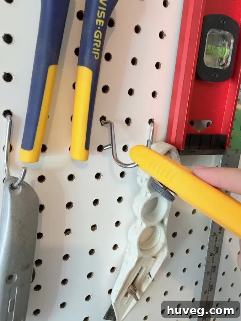Tools detached from the pegboard due to loose hooks