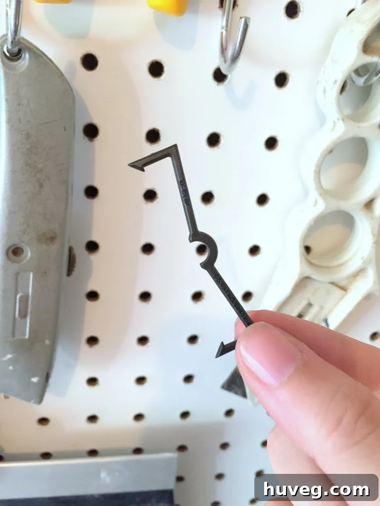 Close-up of a plastic pegboard hook lock