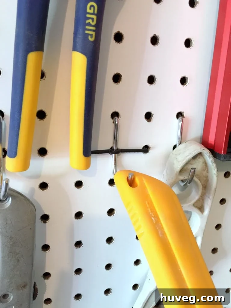 Secure pegboard hook after installing the locking clip