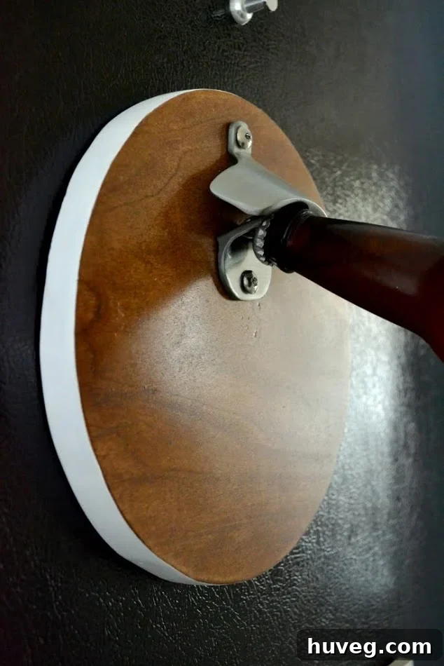 Close-up of a finished round scrap wood magnetic bottle opener, showcasing its craftsmanship.