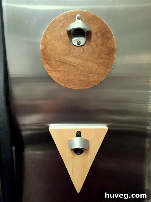 Evening view of the round and triangle scrap wood bottle openers mounted on the side of a refrigerator, showcasing ambient light.