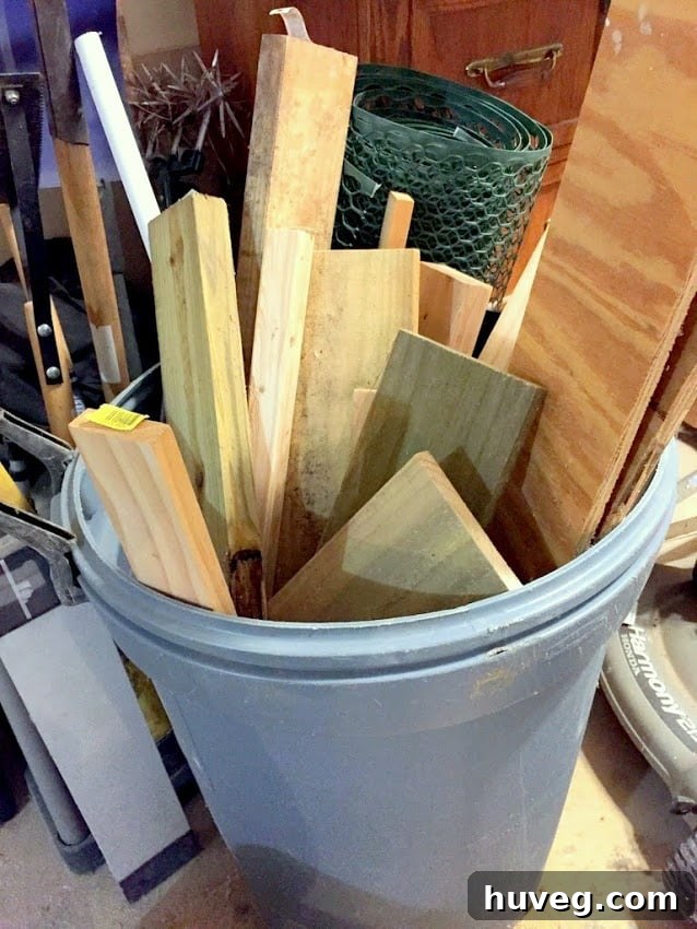 Blue trash can overflowing with various sizes and types of scrap wood, illustrating poor storage.