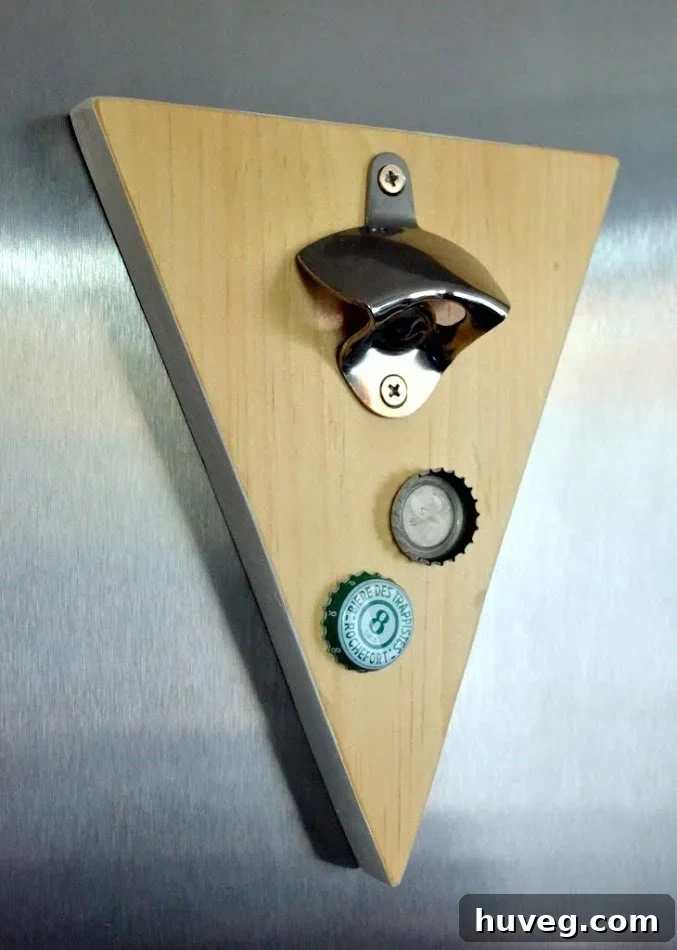 Magnetic wall-mounted beer bottle opener crafted from scrap wood, showcasing a unique design.
