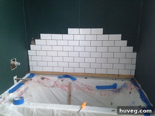 Kit's unfinished bathroom tiling project at Black Feather Farm before collaboration