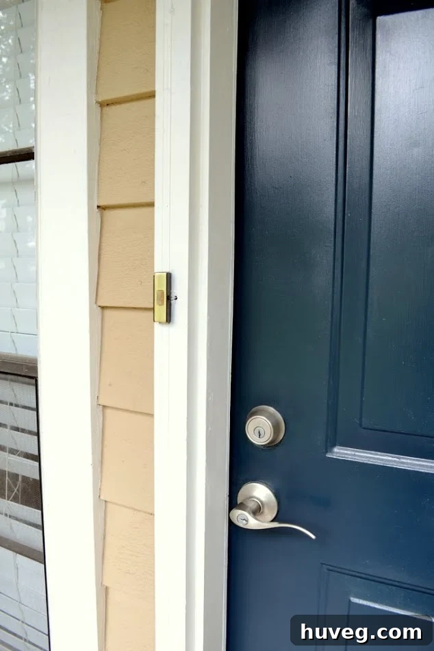 My navy blue front door with nickel finish accessories doesn’t match the old brass-finish doorbell