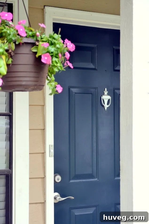My navy blue front door looks great with white trim and nickel accents. The new doorbell matches the rest of the porch perfectly