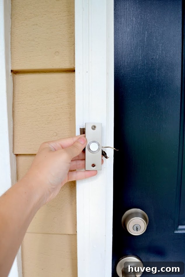 The new doorbell aligned with the old doorbell location quite well and looked great with the white doorframe and navy blue door