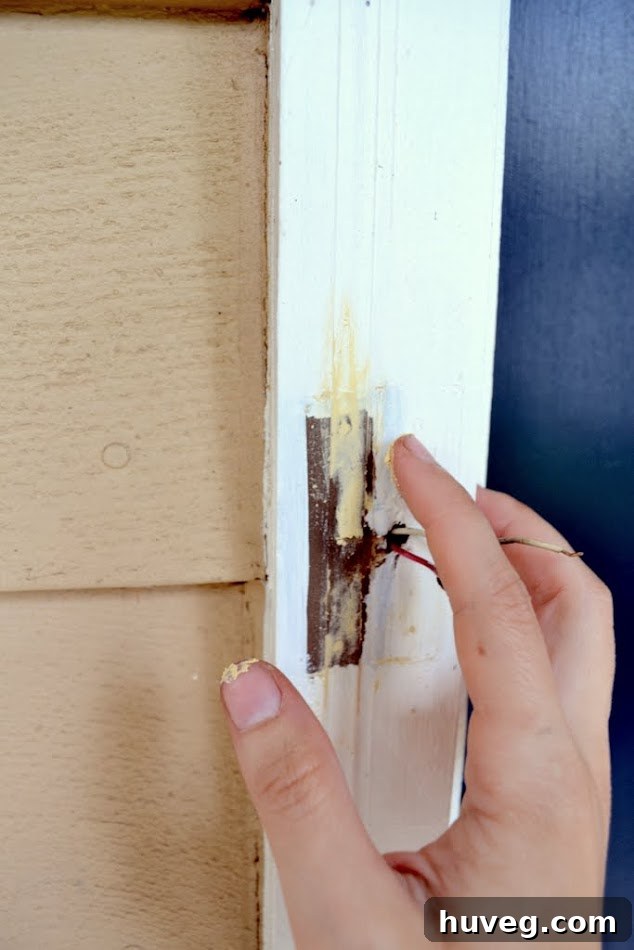 I used my finger to smooth wood filler into the holes made by the old doorbell on the white door frame