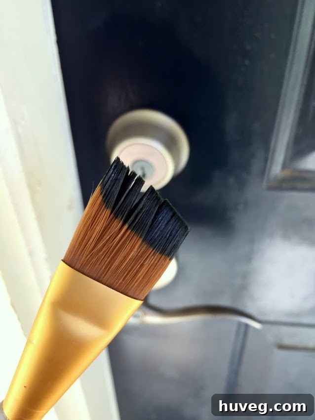 Freshly painted area around the new front door hardware, covering old paint.
