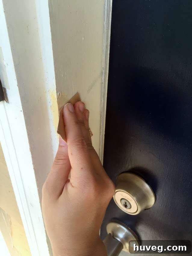 Close-up of the fully repaired and repainted door and new hardware, looking pristine.