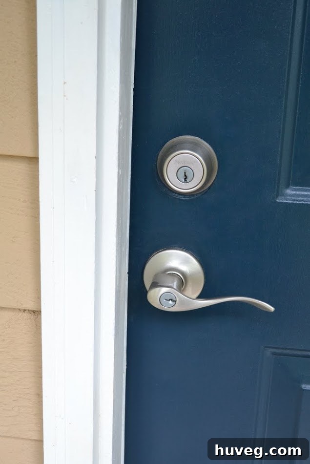 After photo of the completely renovated front door with new hardware and fresh paint.
