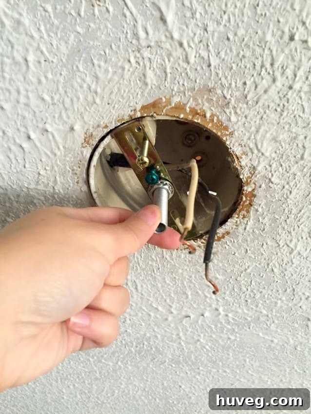Newly installed modern light fixture with LED bulbs in a garage