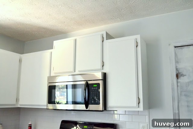 Another view of the newly painted kitchen walls, showcasing the smooth finish and neutral color palette.