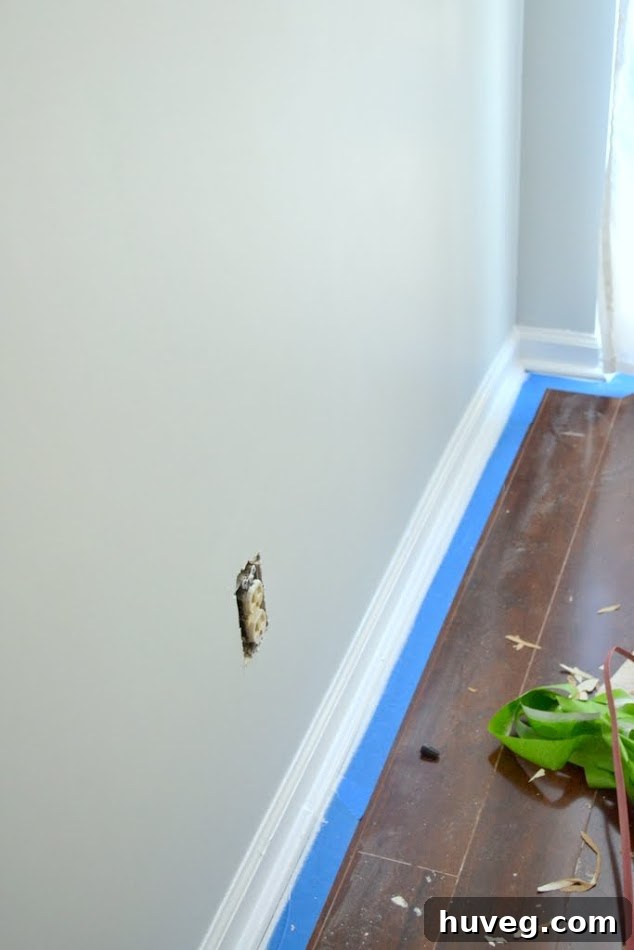 Newly painted kitchen walls, showing areas where baseboards and outlets still need attention.