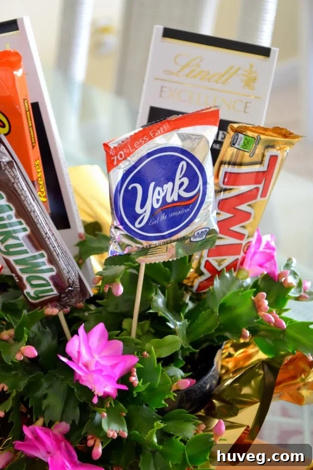 Close-up of a DIY candy bouquet showcasing various chocolates and candies emerging from a potted plant.