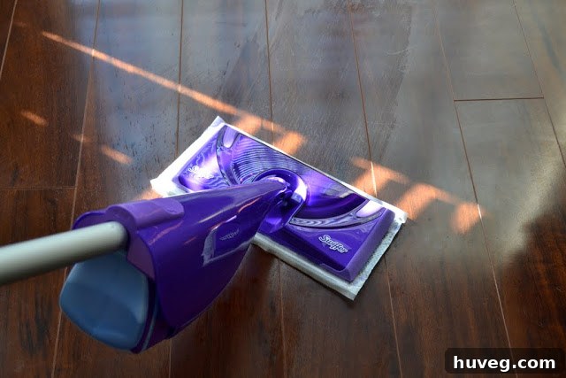 Swiffer WetJet being used to clean the laminate floors near the Christmas tree.