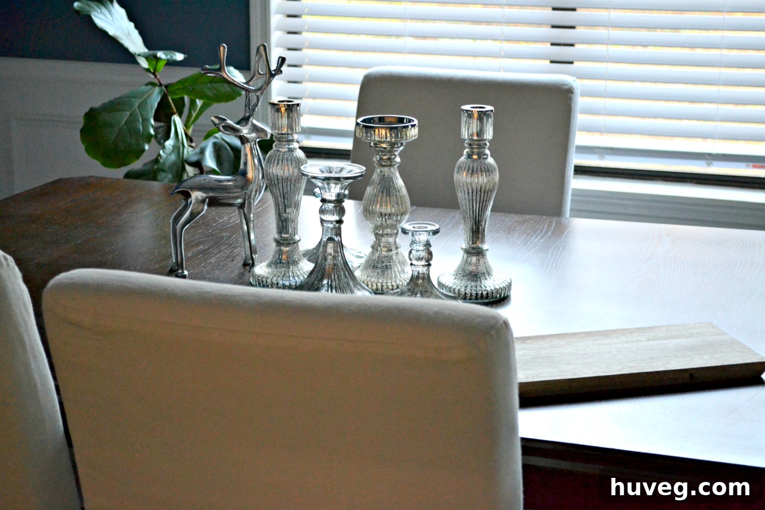 dining room with a blue accent wall and natural light