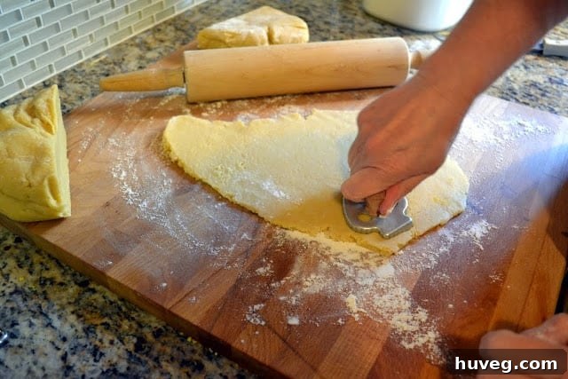 soft sugar cookie recipe being cut out with vintage cookie cutters