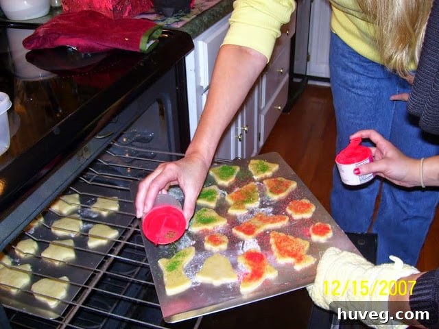 making hard boiled egg cookies for Christmas and sprinkling red and green sanding sugar on top before baking