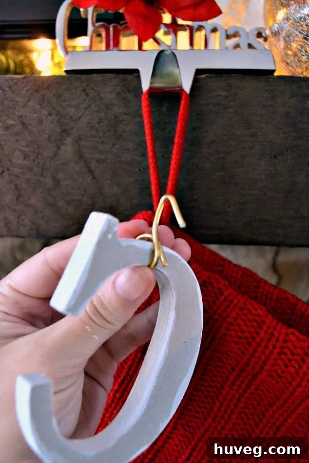 Detailed view of creating a hook with gold floral wire on a letter