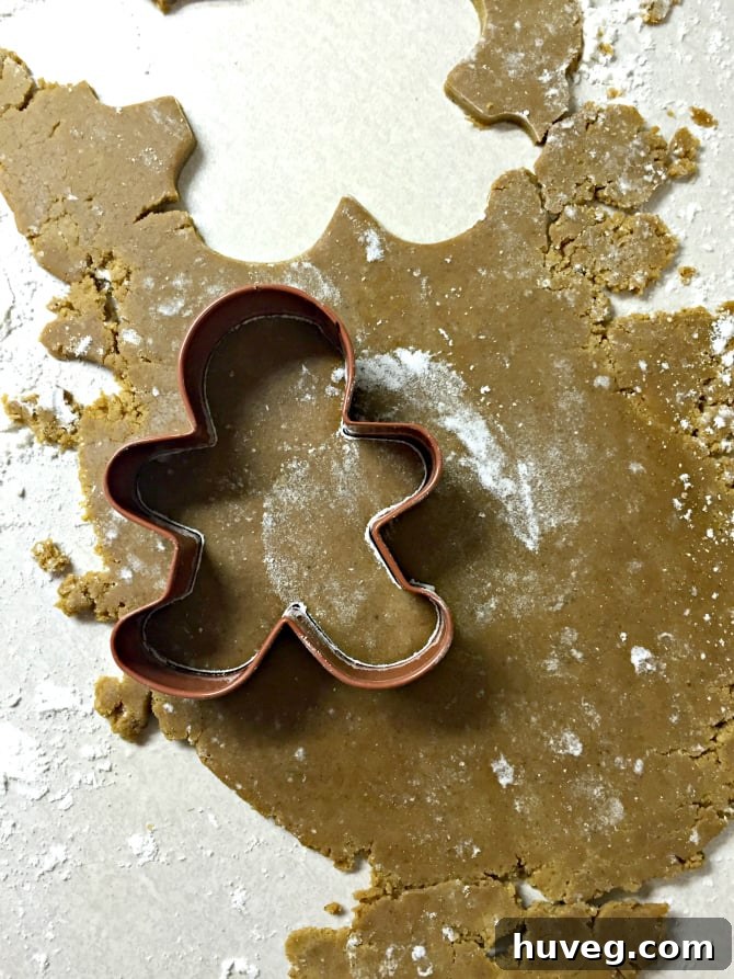 Freshly baked and decorated gingerbread cookies, artfully arranged on a cooling rack, showcasing intricate icing details.