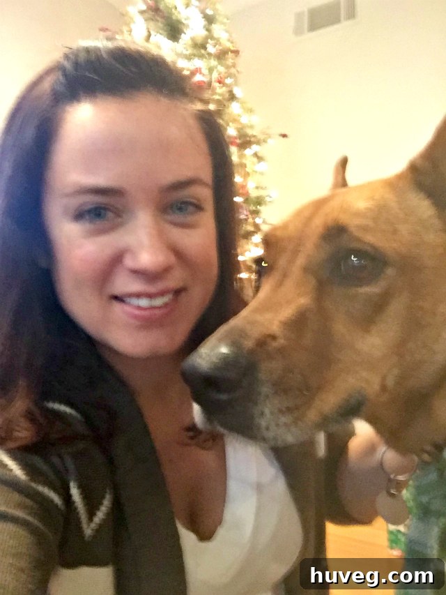 A festive Christmas photo capturing a heartwarming moment between Charlie, the dog, and her owner, in a cozy holiday setting.