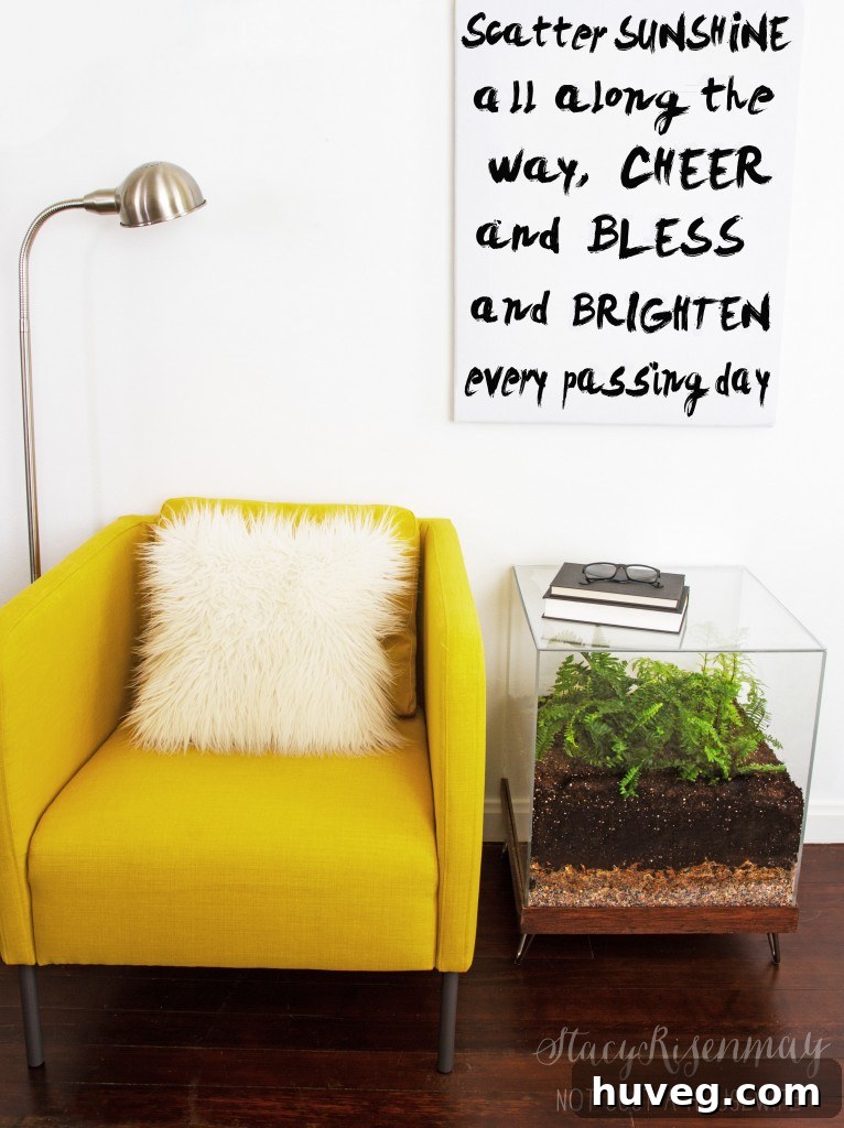 A unique DIY terrarium side table by Not Just a Housewife, featuring an enclosed botanical display.