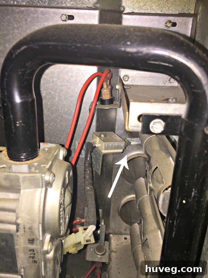 Detailed shot of a hot surface igniter within a furnace, a common component for electronic ignition systems.