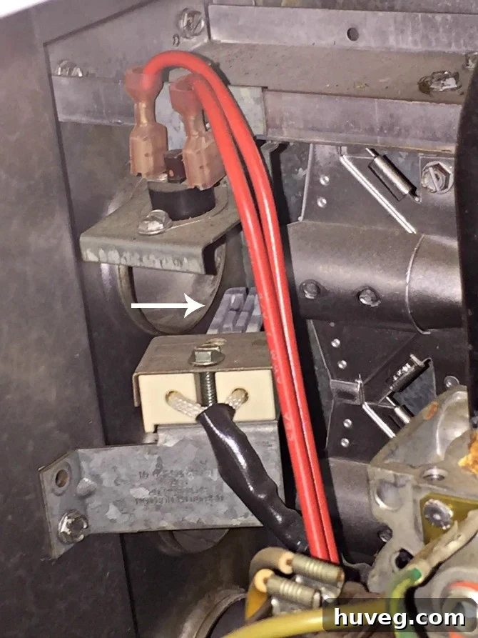 A hot surface igniter with a visible discoloration, initially suspected to be a crack.