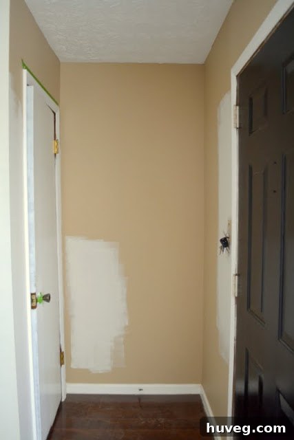 Dated tan entryway transformed with a fresh coat of almost-white paint, showing closet area.
