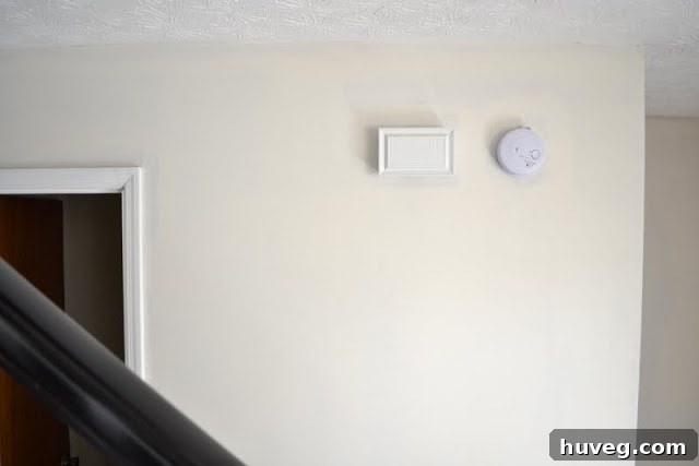 View of the newly painted cream walls in the entryway, showcasing the bright and refreshed aesthetic.