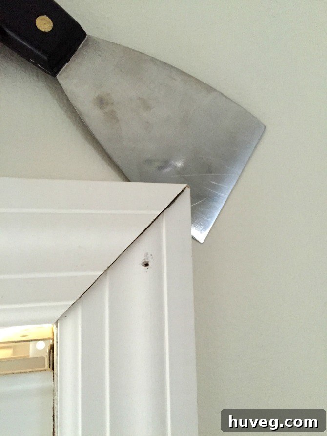 adjusting depth of window casing with putty knife