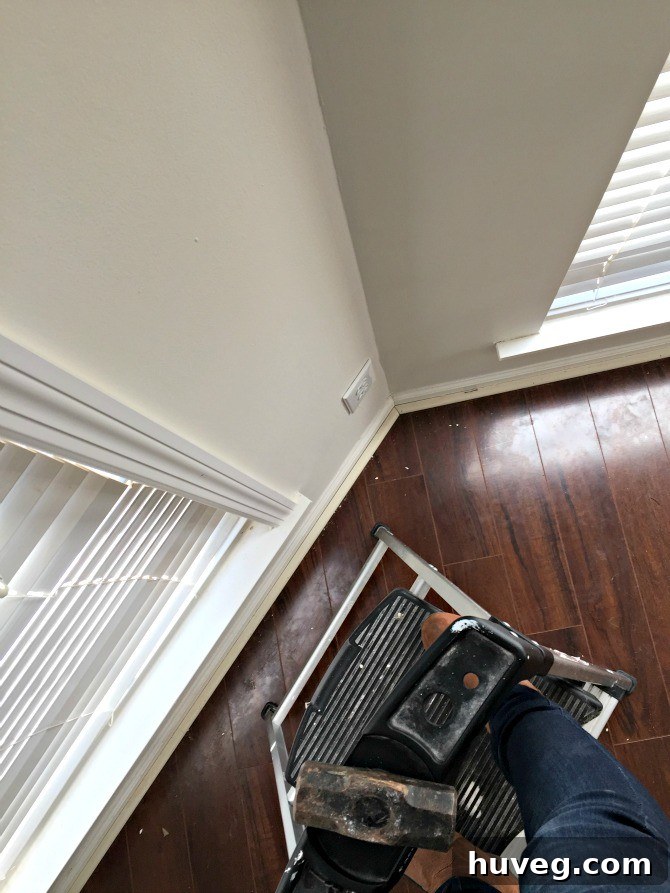 ladder and mallet for trim installation