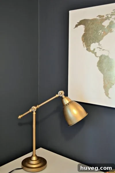 Close-up of the IKEA Barometer lamp's base, showcasing the stunning brushed gold leaf paint finish.