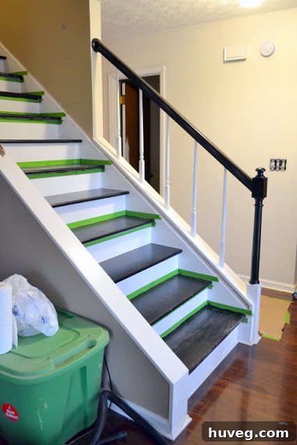 Close up of unfinished banister and wall damage on stairs
