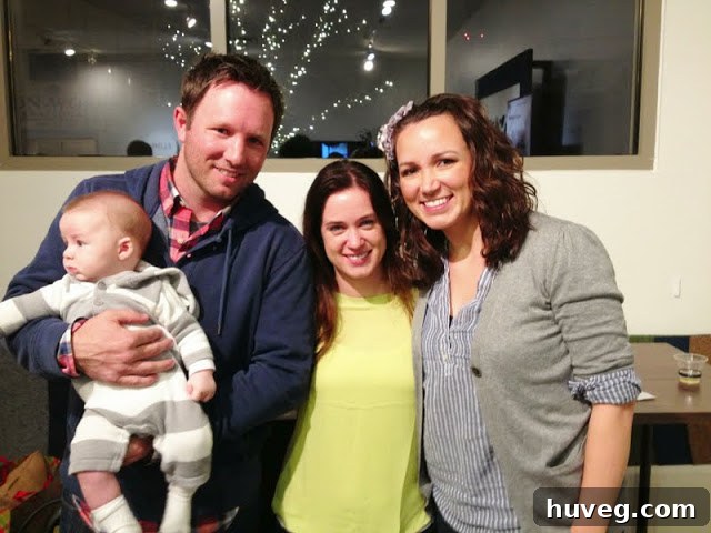 Author and Katie Bower posing for a photo at the book signing, with baby Weston looking away.