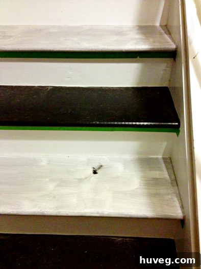 Close-up of freshly painted black stair treads
