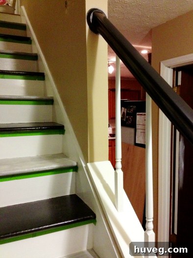 Stylish black handrail against a newly painted wall