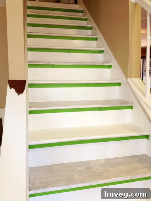 Carefully taping the stair treads