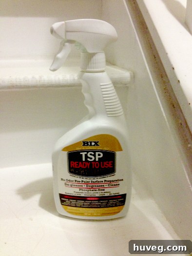 Spray bottle of TSP cleaner on stair treads during cleaning process