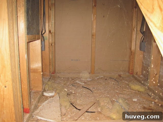 More trash and debris visible underneath the staircase structure