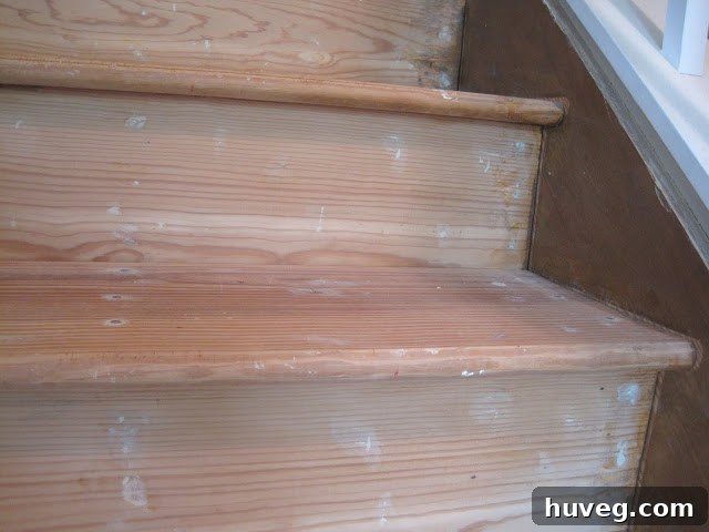 Stairs with replaced treads and wood filler applied to holes and imperfections