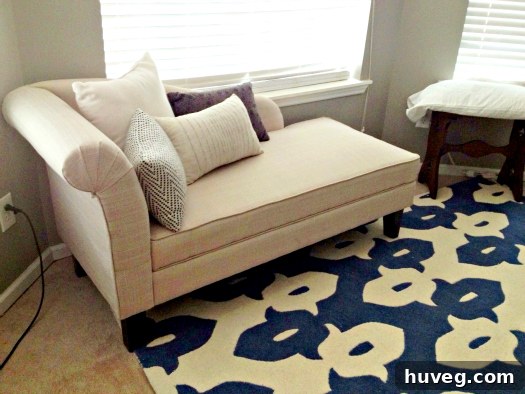 Overall view of the transformed bedroom showing the chaise and rug