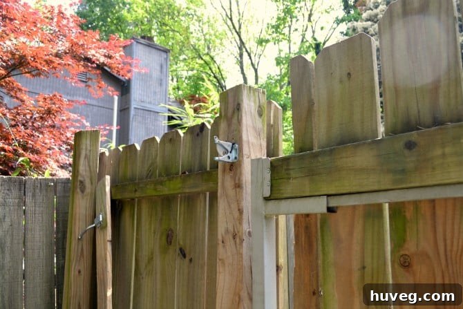 Broken gate and fence showing structural damage to the picket