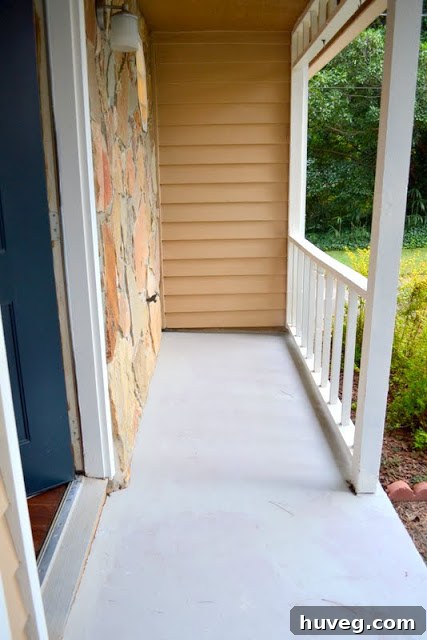 Newly painted front stoop slab, showcasing the updated exterior and plans for a darker shade