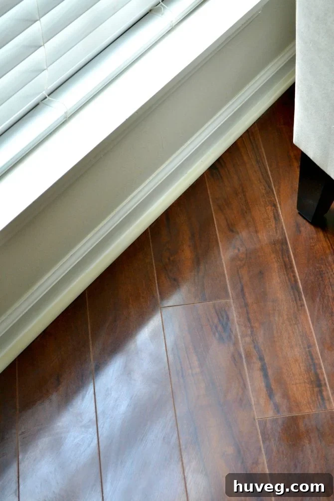 Clean dark floor after Swiffer cleaning, with caulked molding