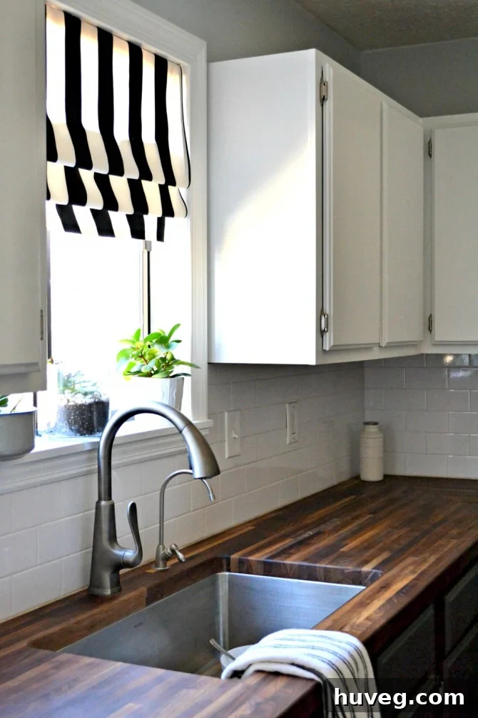 Bright kitchen window view over a sink with a modern faucet