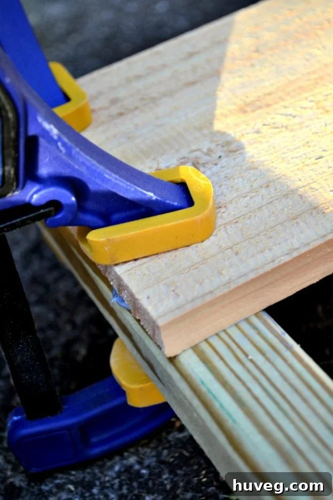 Clamps help hold the wooden pieces of the AC cover screen together while the Liquid Nails dries. 