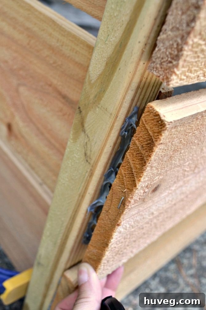I attached the side panels to the posts of the middle panel.